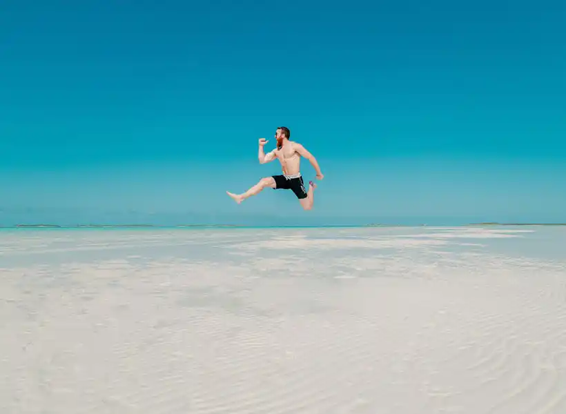 Travelling - Man jumping on a beach